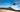 Aeroo Pro fishing drone with bait release flying over Australian beach - shop at Vision Plus Hobart and Brisbane